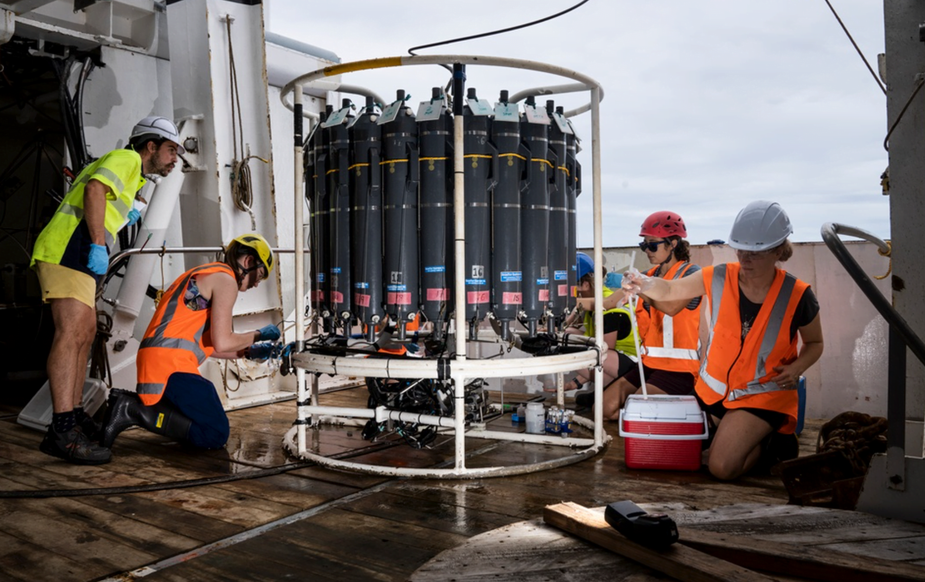 3 Researchers collect water from the CTD after a deployment