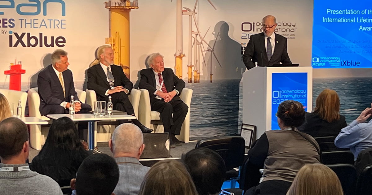 (From left to right): Triton CEO Patrick Lahey, deep-sea explorer Victor Vescovo, and Captain Don Walsh on stage for Dr. Rick Spinrad's address at Oceanology International 2022. (Image credit: ON&T)