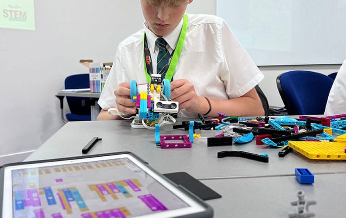 A pupil building a model wheeled ROV out of Lego as part of the GUH STEM Challenge competition. (Image credit: GUH) 