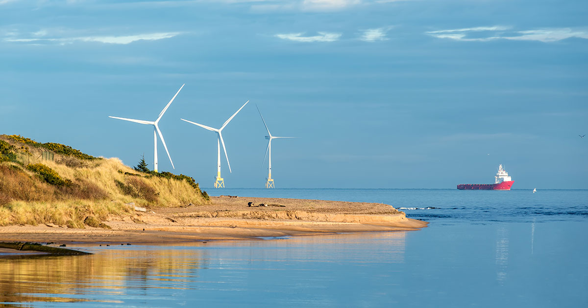 Offshore wind turbine farm, offshore supply vessel and Don River Delta on Scotland coast of Aberdeen, UK