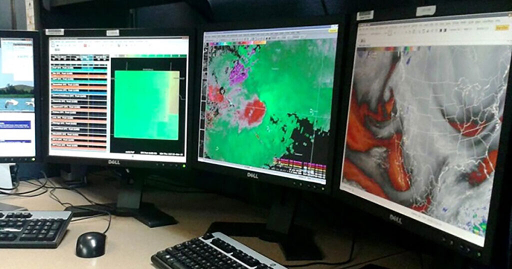 Atmospheric data is displayed on computer screens, part of the Advanced Weather Interactive Processing System (AWIPS) used by meteorologists at NOAA's National Weather Service.