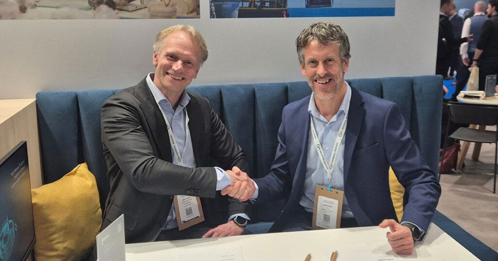 Mark Heine and Audun Berg shaking hands after signing the framework agreement.