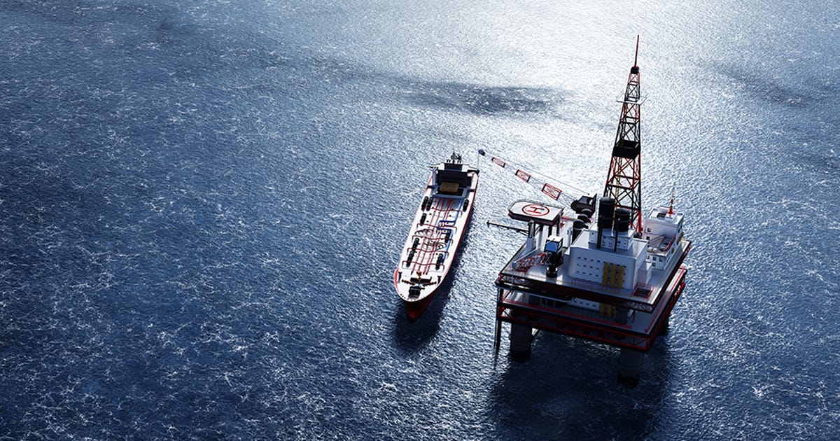 Oil platform on the ocean. Offshore drilling for gas and petroleum. Supply vessel alongside. Industrial