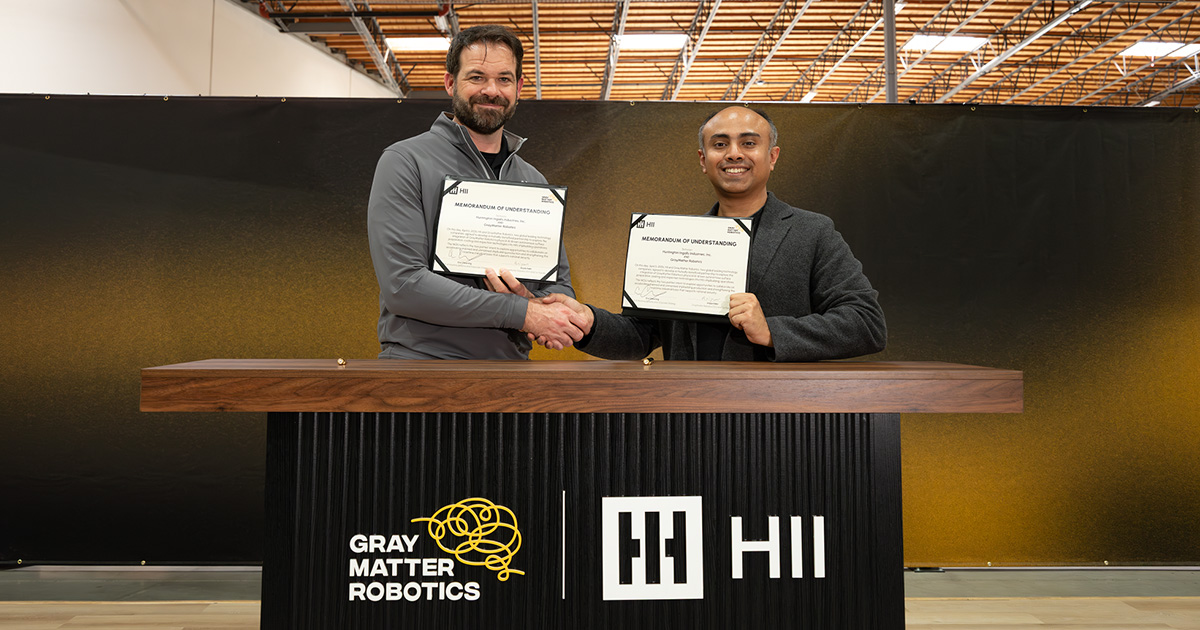 Eric Chewning, HII’s executive Vice President of Maritime Systems and Corporate Strategy (left), and Ariyan Kabir, GrayMatter Robotics CEO and Co-Founder, sign a memorandum of understanding to integrate Physical AI into manned and unmanned shipbuilding during a ceremony at GrayMatter Robotics’ headquarters in Carson, California. (Image credit: GrayMatter Robotics)