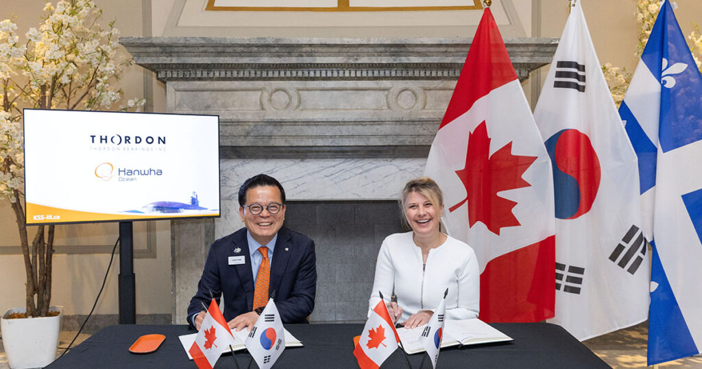 Charlie SC Eoh, President/COO of Naval Ship Business, Hanwha Ocean, and Anna Galoni, CEO, Thordon Bearings, sign MOU for Royal Canadian Navy Submarine project.