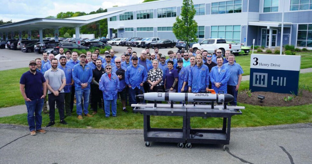 Employees of HII's Unmanned Systems group pose outside HII's facility in Pocasset, Massachusetts, with the first REMUS 130 unmanned underwater vehicle delivered to a US ally. The delivery marks a major milestone for the next generation of the world's most widely deployed autonomous underwater vehicle.