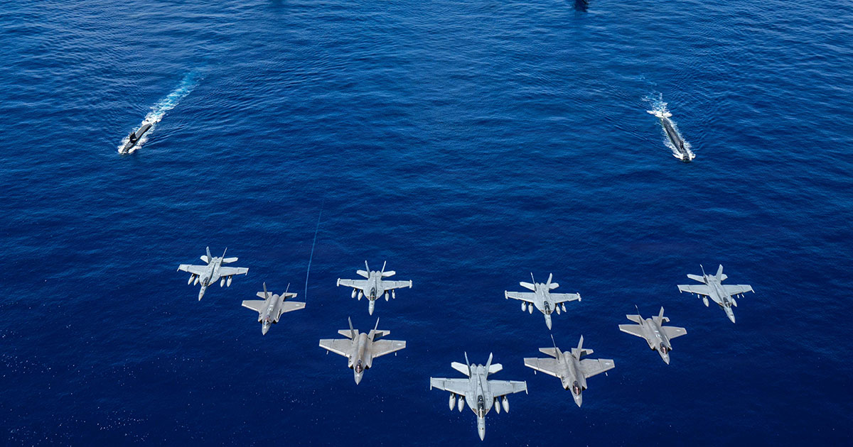 US Navy aircraft, attached to Carrier Air Wing (CVW) 5, and US Air Force F-35A Lightning IIs fly over US Navy George Washington Carrier Strike Group as it sails in formation with Japan Maritime Self- Defense Force as part of Valiant Shield 2026 while underway in the Philippine Sea, June 21, 2026.