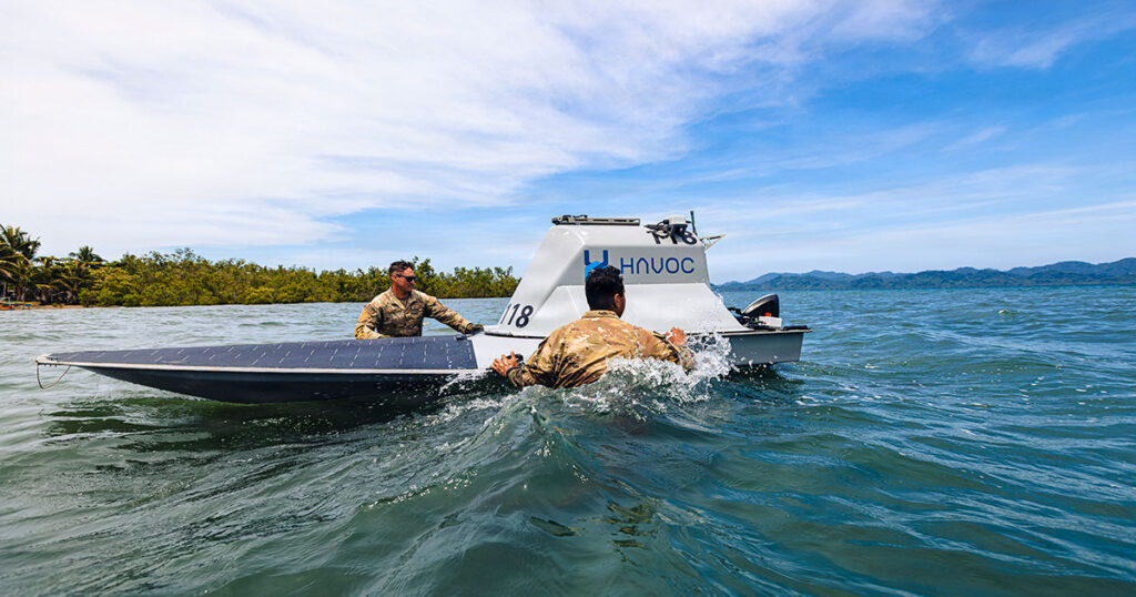 US Army Pfc. Ethan Lair (left) and Spc. Jeremiah Ortiz (right), assigned to the 125th Intelligence and Electronic Warfare Battalion, 25th Infantry Division Artillery, 25th Infantry Division, recover an unmanned surface vessel during Exercise Salaknib 2026 at Casiguran, Philippines, June 9, 2026.