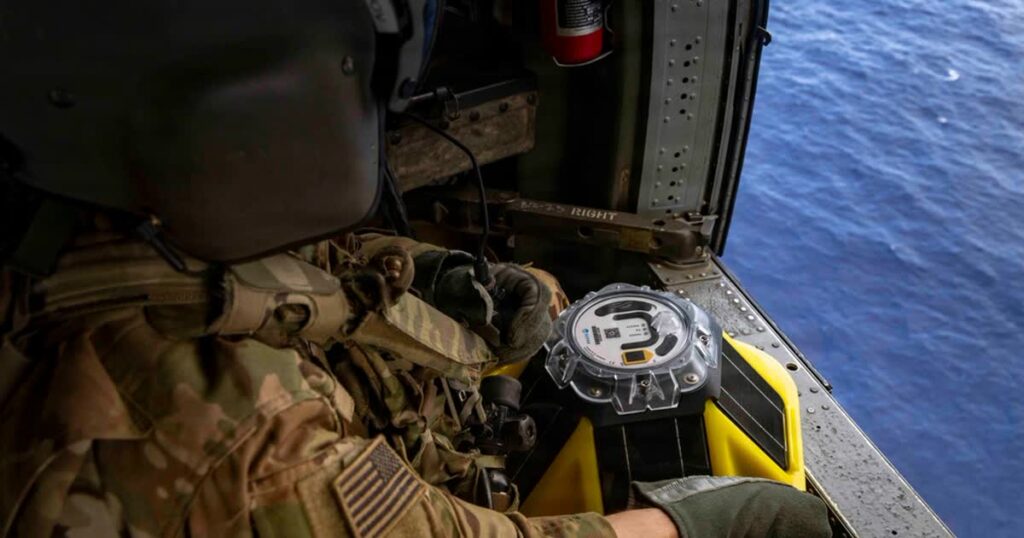 US Army Spc. Ernest Useinov, a UH-60 helicopter repairer serving as a crew chief assigned to Task Force Saber, 25th Combat Aviation Brigade, holds an ocean buoy sensor while flying over open water as part of Exercise Balikatan 2026 over the Luzon Strait, Philippines, April 28, 2026. (Image credit: Sgt. Olivia Cowart, US Army, The appearance of US Department of War (DoW) visual information does not imply or constitute DoW endorsement)