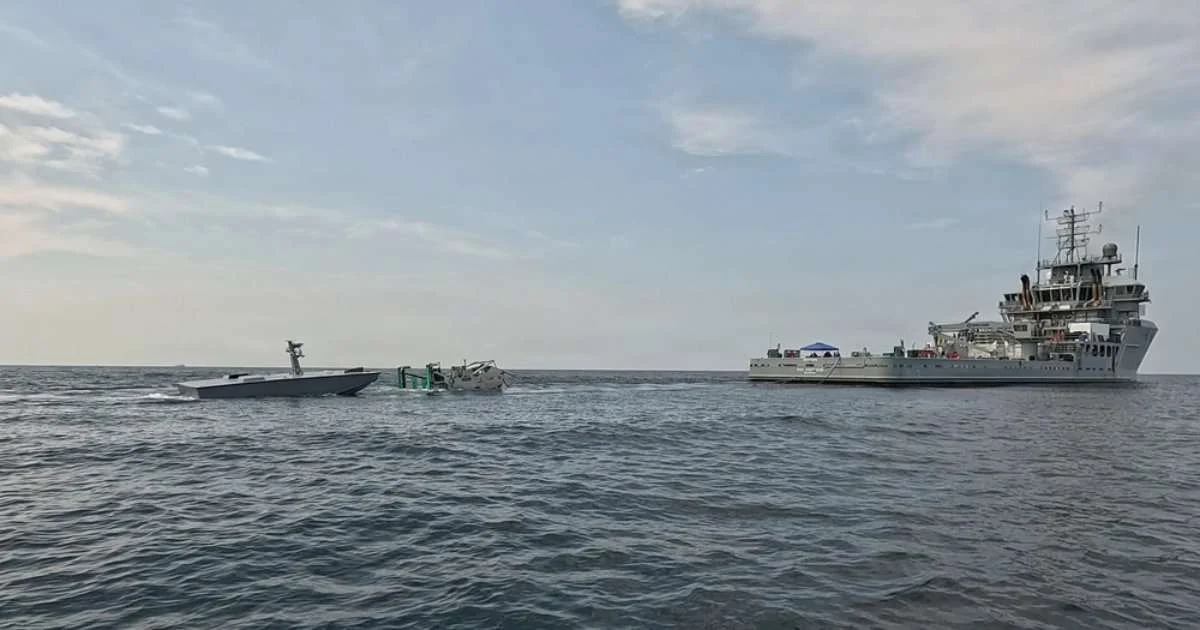 The T38 unmanned surface vessel, left, approaches a towable capture and connection device, center, towed by USNS Vindicator (TSV 5), right, during an Aug. 11 refueling demonstration off Joint Expeditionary Base Little Creek-Fort Story, Virginia. Naval Air Warfare Center Weapons Division’s Blue Water Instrumentation program led the demonstration, part of an effort to keep unmanned vessels on station longer during long-range weapons testing. (Image credit: Naval Air Warfare Center Weapons Division)