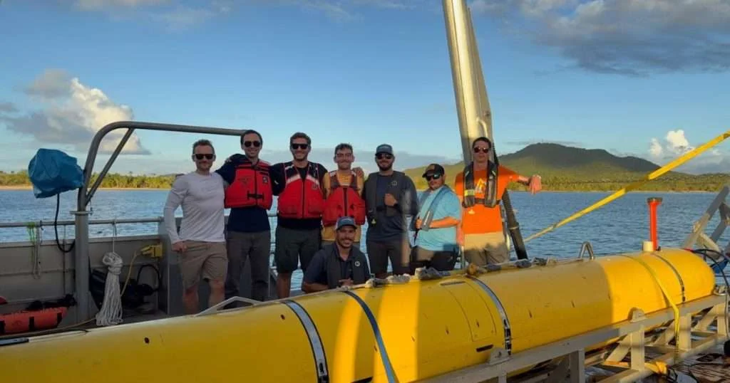 Members of the US Naval Research Laboratory autonomous underwater vehicle measurement team, General Dynamics Mission Systems contractor support and Blue Manta crew pose with the Skyfish autonomous underwater vehicle aboard the research vessel Blue Manta near Vieques, Puerto Rico, June 28, 2026. The team conducted at-sea demonstrations of the Skyfish AUV-based structural acoustic active sonar system to evaluate its ability to detect and classify submerged unexploded ordnance. (Image credit: US Navy)
