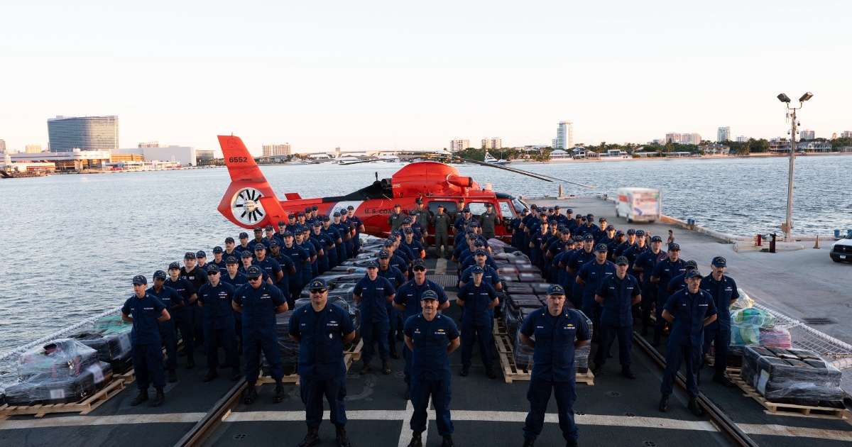 U.S. Coast Guard Cutter Tampa crew members pose with seized contraband during a drug offload at Port Everglades, Florida, Oct. 14, 2026. The crew offloaded approximately 29,600 pounds of cocaine and 3,355 pounds of marijuana, valued at an estimated $226.7 million, resulting from six interdictions in international waters of the Eastern Pacific Ocean.