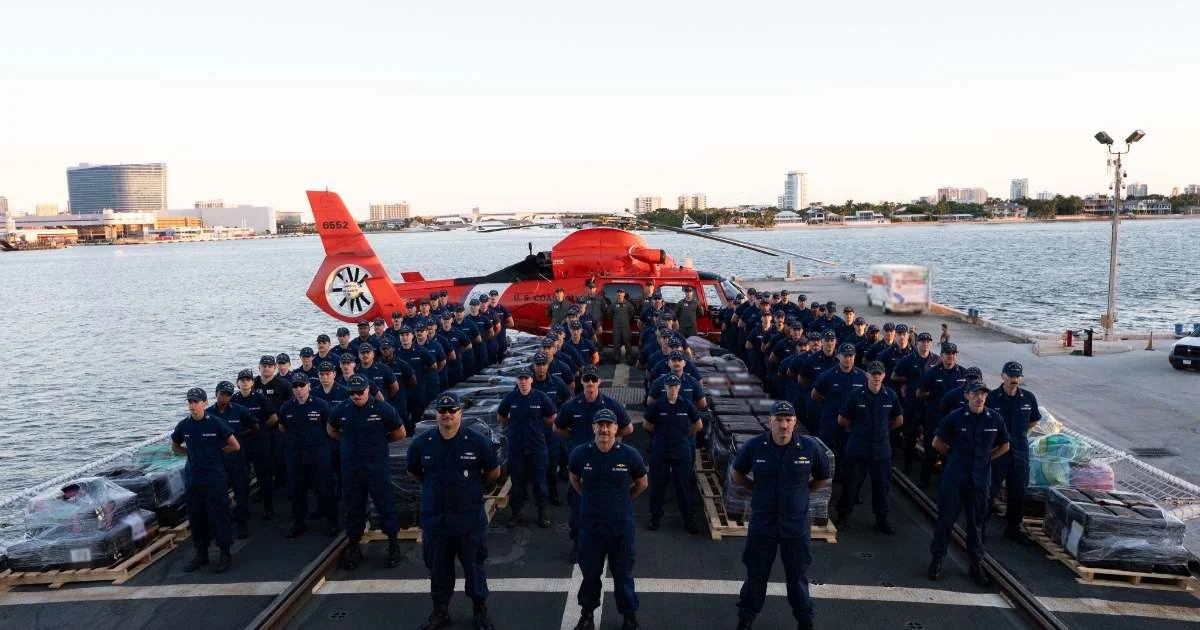 U.S. Coast Guard Cutter Tampa crew members pose with seized contraband during a drug offload at Port Everglades, Florida, Oct. 14, 2026. The crew offloaded approximately 29,600 pounds of cocaine and 3,355 pounds of marijuana, valued at an estimated $226.7 million, resulting from six interdictions in international waters of the Eastern Pacific Ocean.